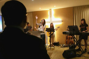 You Qian leading worship during service